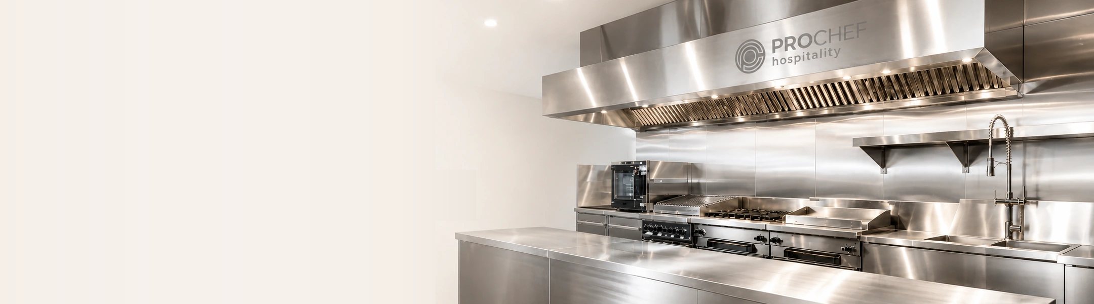 Bright commercial stainless-steel kitchen with the ProChef Hospitality logo integrated into the extraction hood.