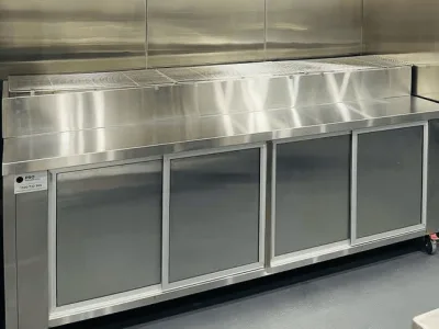 Stainless steel storage cabinet installed along the kitchen wall