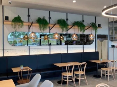 Banquette seating and timber tables in the Caffe and Co. dining area