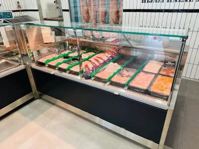 Refrigerated display cabinet stocked with fresh cuts