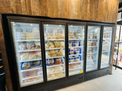 Upright glass door freezers carrying packaged lines