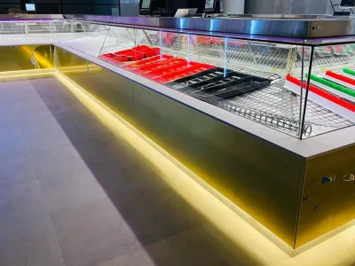 Detail of the refrigerated serve-over cabinet and brass plinth